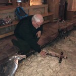 Father Roy Praying at the stone where Jesus prayed and sweat blood before his arrest in the Garden of Gethsemani