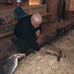 Father Roy Praying at the stone where Jesus prayed and sweat blood before his arrest in the Garden of Gethsemani